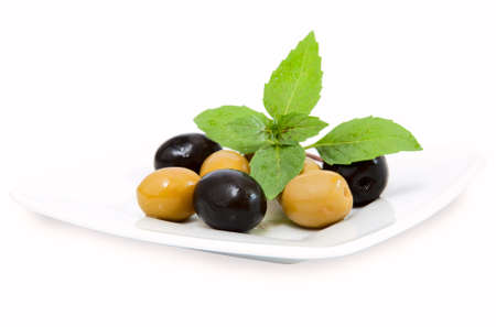 black and green olives on white plateの写真素材