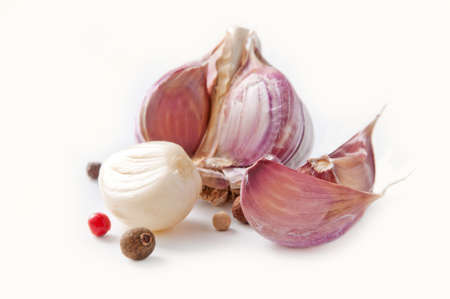 Garlic cloves and pepper on a white background の写真素材