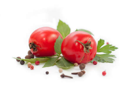 red tomatoes,basil and pepper on white backgroundの写真素材