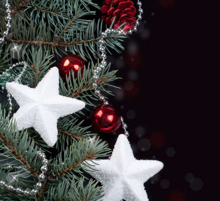fir branch and Christmas decorations on a black backgroundの写真素材