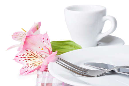 Cup of coffee, flowers and plate on a white backgroundの写真素材