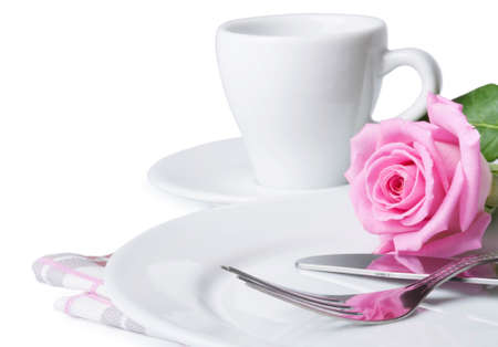 Cup of coffee, rose and plate on a white backgroundの写真素材