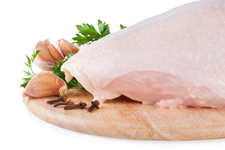 Raw chicken breast with green parsley, spices and garlicの写真素材
