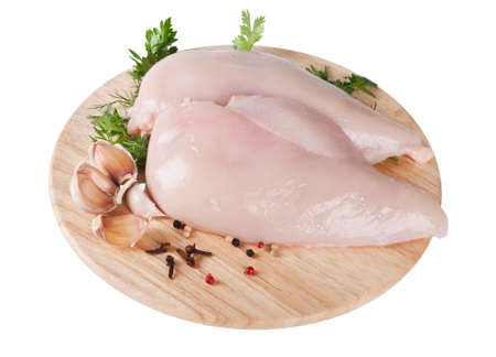 Raw chicken fillet on board with parsley and garlicの写真素材