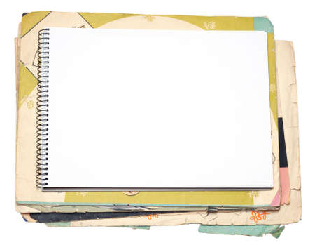 Blank notebook and old paper sheet on a white backgroundの写真素材