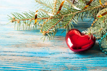 Christmas decorations and fir branch on a blue wooden backgroundの写真素材