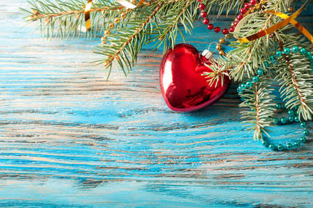 Christmas decorations and fir branch on a blue wooden backgroundの写真素材