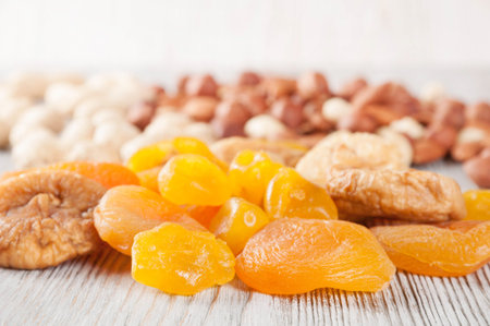 Dried fruits and nuts on a wooden background. Candied fruits, lemon, apricot, fig and nuts.の写真素材