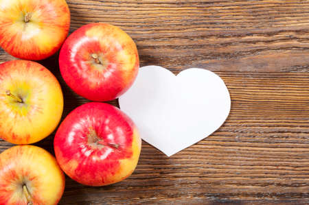 Ripe red apples on a wooden background. Top view. Vegan concept.の写真素材