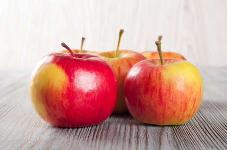 Ripe red apples on a wooden background.の写真素材