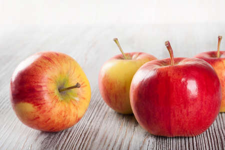 Red ripe apples on a wooden tableの写真素材