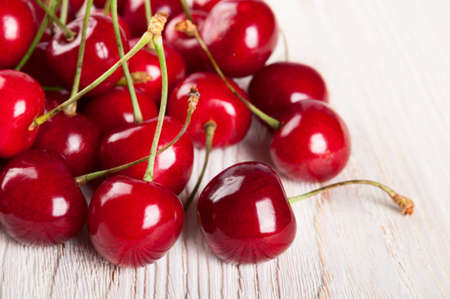 Red ripe sweet cherry on a wooden backgroundの写真素材