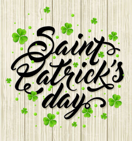 Lettering and green clover leaves on a wooden background. Greeting card for St. Patrick's Day. Vector illustrationのイラスト素材