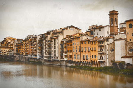 Vintage travel card. Old houses on the Arno River and Ponte Vecchio in Florence, Italyの写真素材