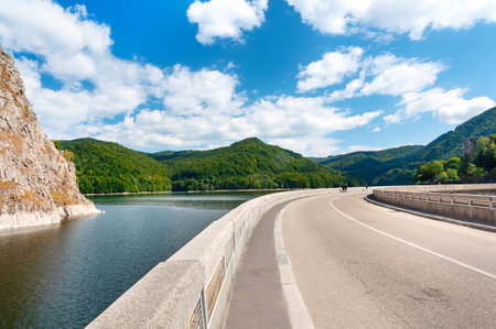 Vidraru artificial lake and dam on Arges river in Transylvania, Romania.  Highway in the Carpathian mountains, Fagaras ridge. Hydro electric power stationのeditorial素材
