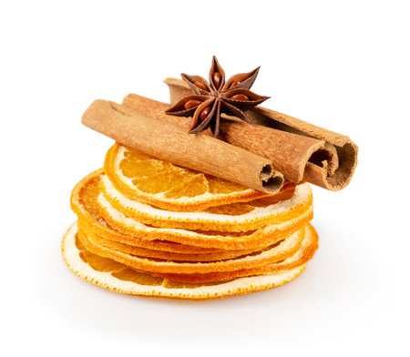 Stack of dried orange slices, cinnamon and star anise. Spices for mulled wine on a white background.の写真素材