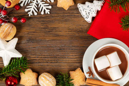 Hot chocolate, Christmas traditional cocoa drink, sweet cookies and decorations on a brown wooden background. Top viewの写真素材