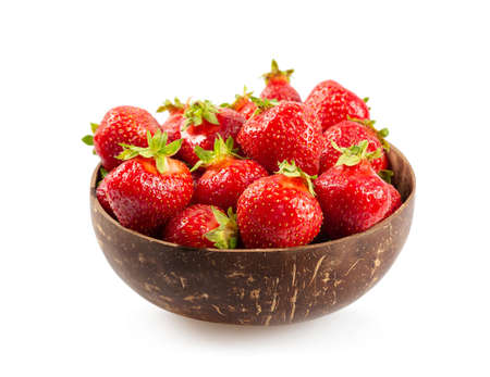 Beautiful juicy ripe red strawberry in a wooden plate isolated on a white backgroundの写真素材