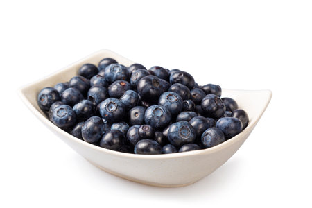 Fresh blueberries in a white plate on a white background.の写真素材