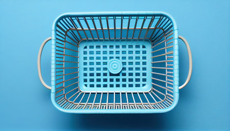 Top view of supermarket shopping basket on light blue. Al generatedの素材