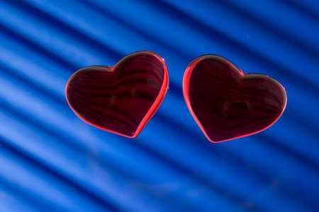 Two heart. Tho glass heart on blue background.の写真素材