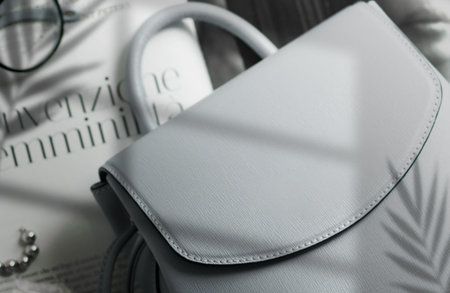 logo mockup template in a trendy style . Grey leather texture women bag on female holding, fashion mockupの写真素材