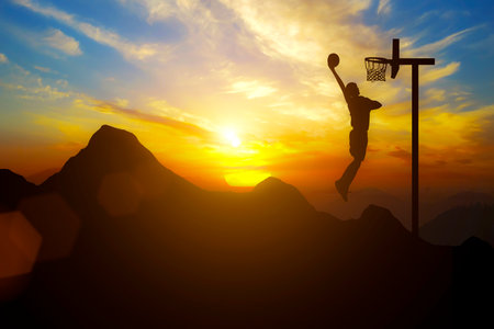 Driving and goals A man places a basketball goal on top of a mountain with sunsetの写真素材