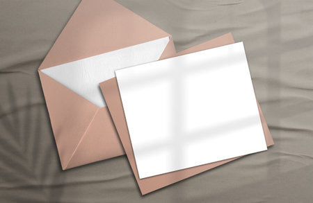 Logo paper template. Square paper mockup in realistic shades with an envelope on a wooden...