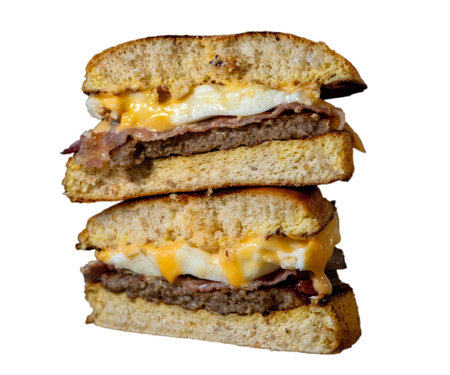 fresh Big double cheddar tasty hamburger. Large fresh burger with meat and cheese isolated on white background . consisting of bun, cheese, salad, red onion and tomatoの写真素材