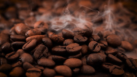 A heap of coffee beans stacked together, ready to be brewed into a delicious cup of coffee .Background of coffee beans with smoke, textureの写真素材
