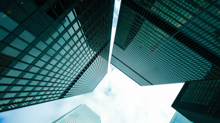 Economics, banking, business and finance concept.A fragment of a modern office building in the capital . glass buildings with cloudy blue sky background .modern office buildingの写真素材