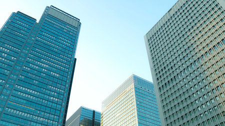 Economics, banking, business and finance concept.A fragment of a modern office building in the capital . glass buildings with cloudy blue sky background .modern office buildingの写真素材