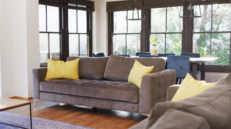 Light living room with comfortable sofa, coffee table and chest of drawers. Interior of light living...