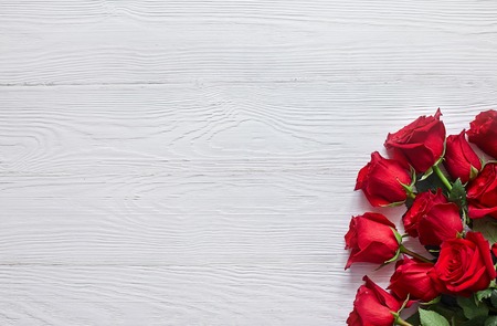 Bouquet of red roses on old white wooden backgroundの写真素材