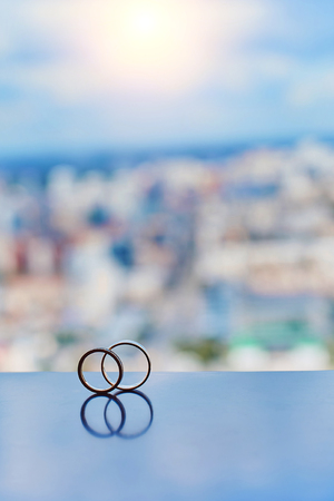 Two gold wedding rings reflectedの写真素材