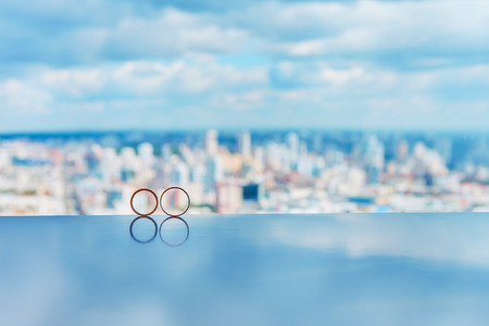 Two gold wedding rings reflectedの写真素材