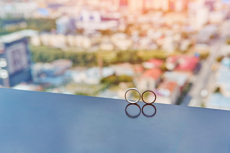 Two gold wedding rings reflectedの写真素材