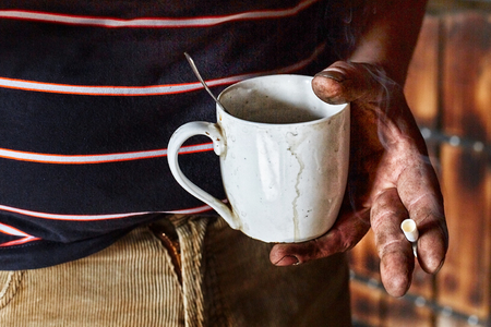 Working miner holding a Cup with a drinkの写真素材