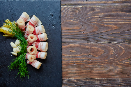 Set of lard with garlic, pepper and green onions.
Russian and Ukrainian cuisine. On a wooden table. View from above. Copy spaceの写真素材