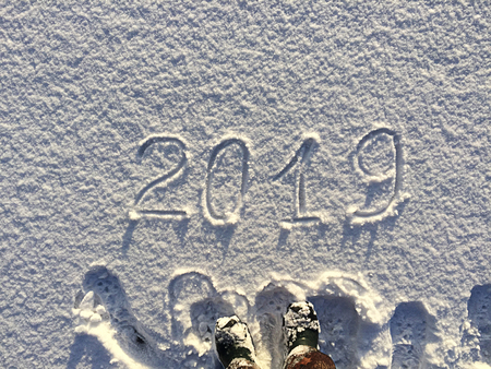 2019. Writings on the snow. Happy new year. Beautiful cold sunny winter day.  The game of light and shadowの写真素材