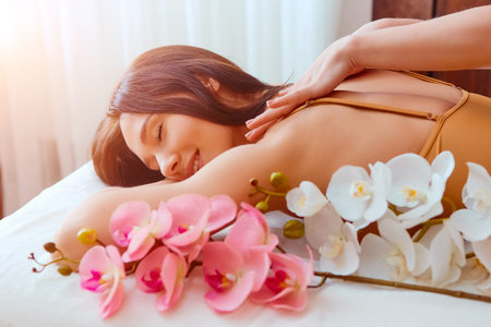 Woman enjoying during a relax massage at the spaの写真素材