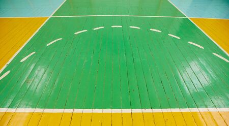 Old cracked floor of the sports hall with markings for basketball.の写真素材