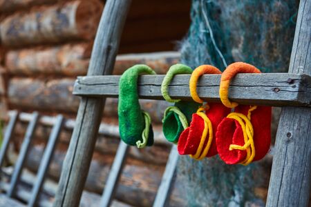 The elves hung their felt shoes on the old wooden ladder to dry.の写真素材