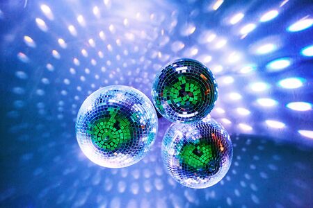 Disco balls with bright rays and highlights at the night disco in the club. Background imageの写真素材