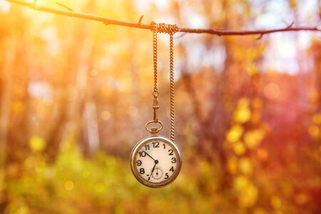 Vintage watch on a chain on an abstract background.の写真素材
