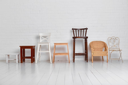 There are many different chairs in the white room. The concept of unity of different.