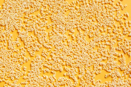 Macaroni Alphabet. A set of ingredients, raw macaroni in the form of letters.   Food background'の写真素材