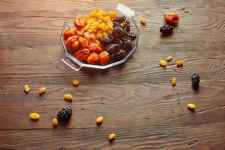 Mix dried fruits collection. On a wooden background. Dried fruits are stored without a refrigerator for a long time.の写真素材