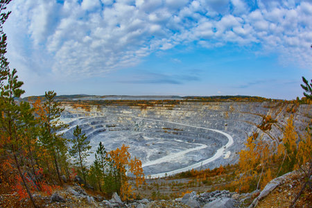 Top view of a huge crater of a stone crushed stone quarry in Russia, Chelyabinsk region, Miass city