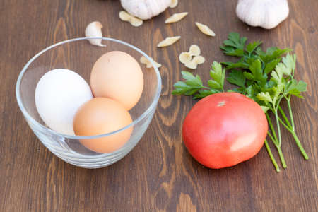 Fresh eggs with vegetables and greensの写真素材